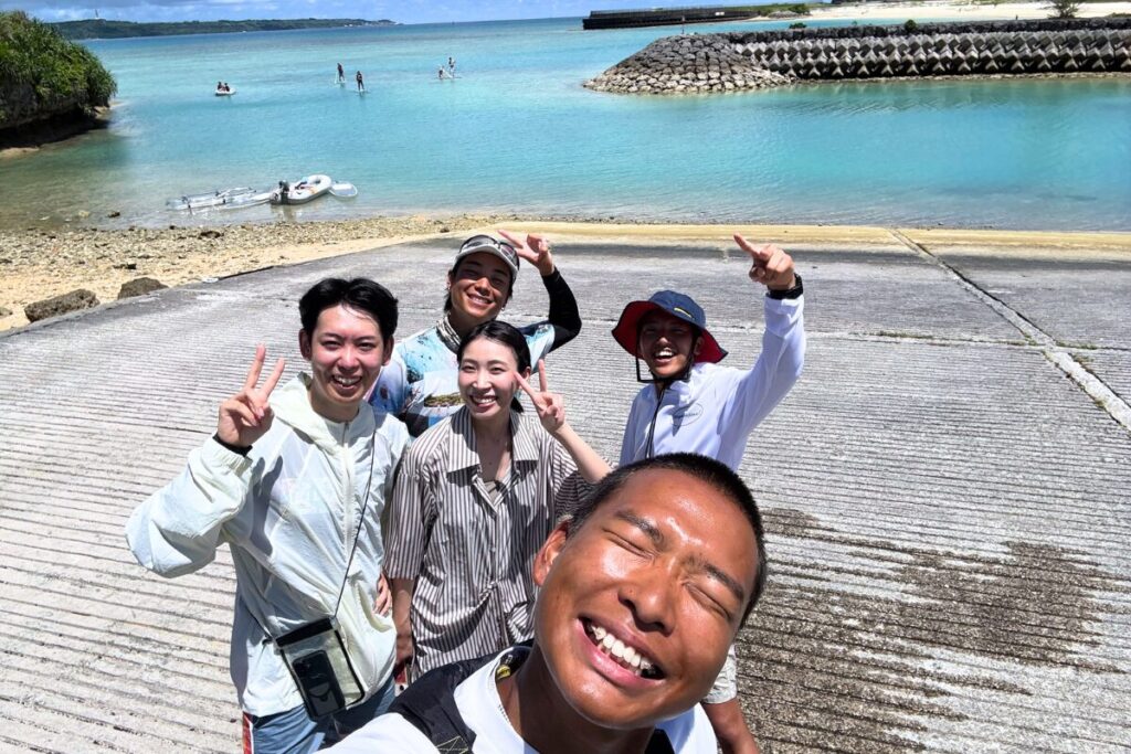 みんなで漁港で記念撮影 お客さんとガイドたちの満面の笑顔