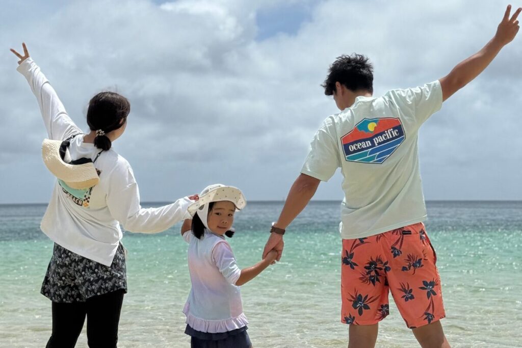 海に向かって家族みんなでピース写真